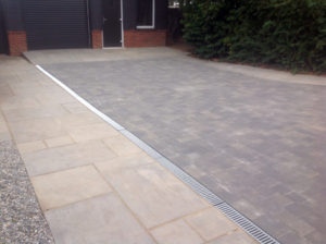 Driveway, Paving and drainage detail using gravel slab and block paving.